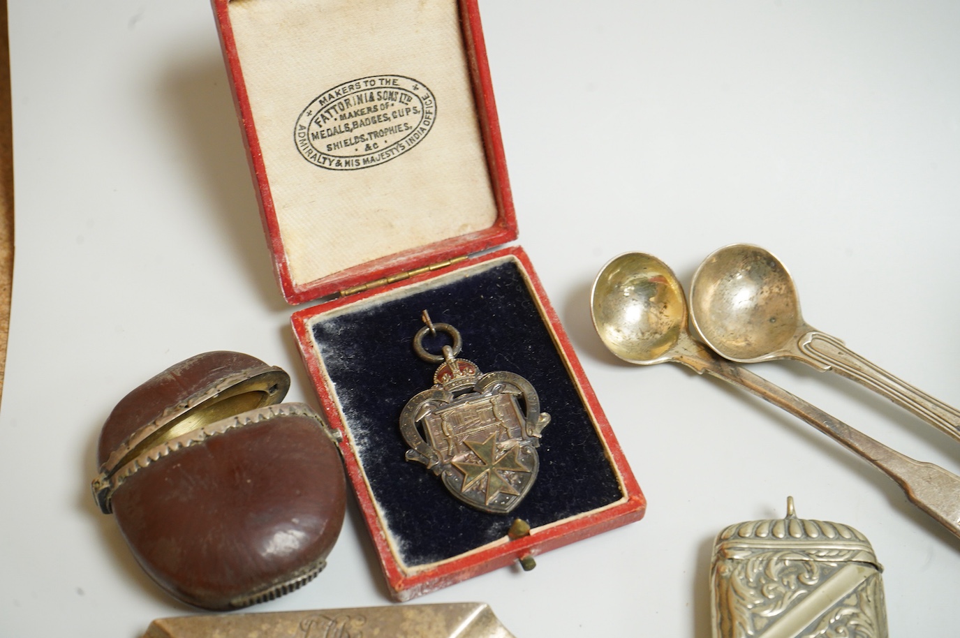 A small collection of silver and white metal charms, including Holy Bible, Penny Farthing, hedgehog and squirrel, together with a silver compact and ashtray, a silver and paste brooch, nut vesta, pipe, etc.